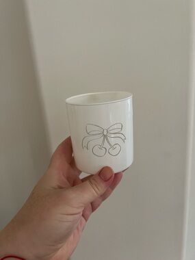 White cup vase with cherry bow on side